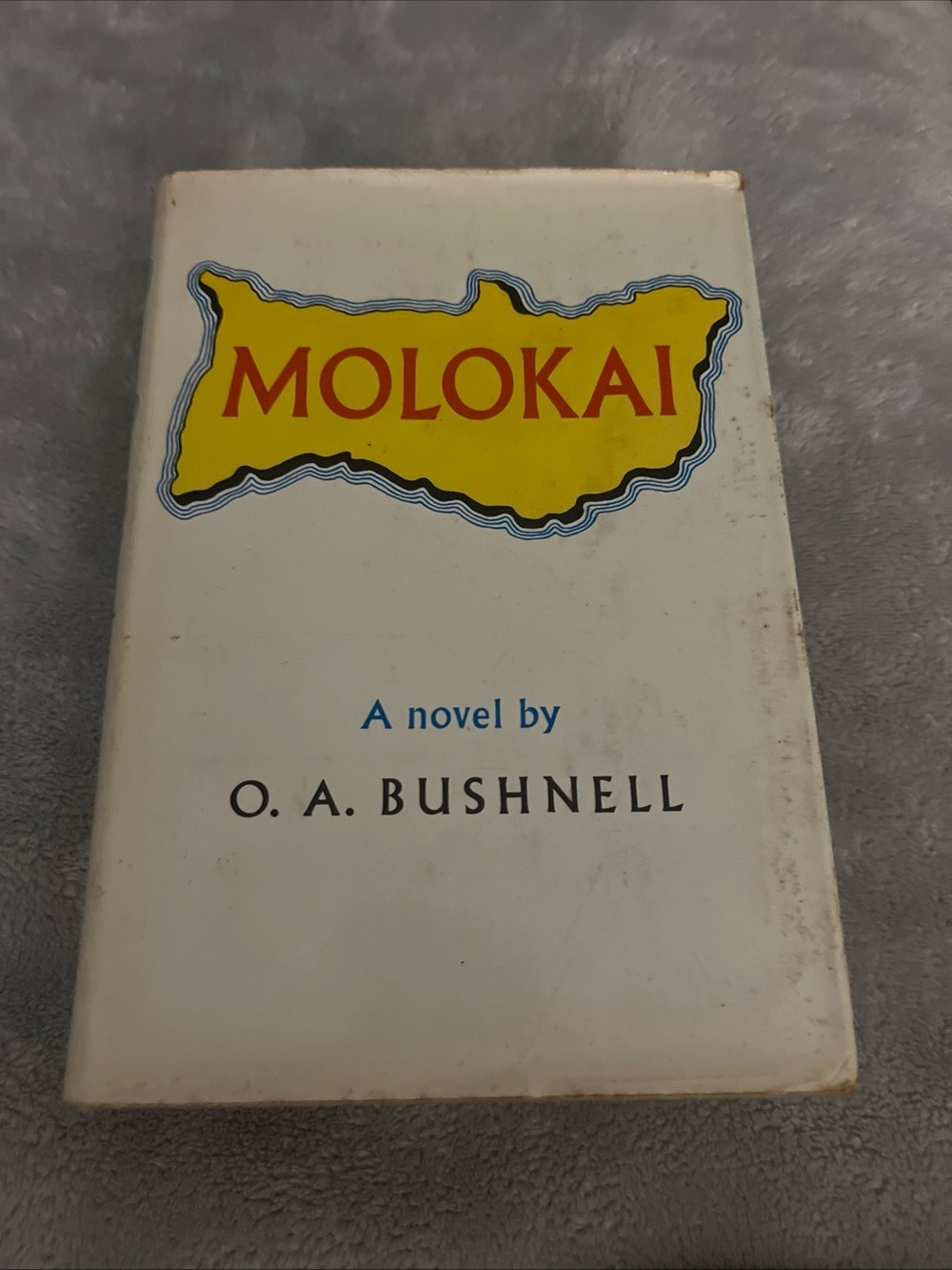 Vintage Molokai by O.A. Bushnell — White Cover with Yellow Logo